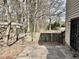 Fenced backyard with patio, bordered by mature trees, providing a private and serene outdoor space at 860 Flat Shoals Rd, Atlanta, GA 30349