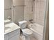 Bathroom with a shower-tub combo, toilet, tile walls and a vanity at 860 Flat Shoals Rd, Atlanta, GA 30349
