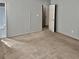 Bedroom with gray walls, tan carpet and a doorway leading to the bathroom at 860 Flat Shoals Rd, Atlanta, GA 30349