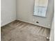 Neutral colored bedroom with gray walls, tan carpet, and a window providing natural light at 860 Flat Shoals Rd, Atlanta, GA 30349
