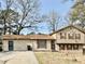 Charming split-level home featuring a well-maintained lawn and classic architectural details at 860 Flat Shoals Rd, Atlanta, GA 30349