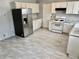 Well-lit kitchen featuring updated appliances and ample cabinet space at 860 Flat Shoals Rd, Atlanta, GA 30349