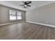Bright bedroom featuring wood-look floors and two windows at 445 Milton Dr, Canton, GA 30114