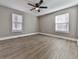 Well-lit bedroom, hardwood floors, and two windows at 445 Milton Dr, Canton, GA 30114