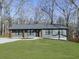 Newly built gray house with dark trim, nestled among trees at 445 Milton Dr, Canton, GA 30114