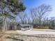 Contemporary gray house with a driveway and wood-toned columns at 445 Milton Dr, Canton, GA 30114