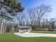 Modern gray house with dark roof and wood accents, nestled in a wooded area at 445 Milton Dr, Canton, GA 30114