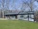 Modern gray house with wood columns and a partially landscaped yard at 445 Milton Dr, Canton, GA 30114