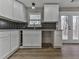 White cabinets and dark tile backsplash are featured in this kitchen with French doors at 445 Milton Dr, Canton, GA 30114