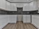 This kitchen features white cabinets, dark tile backsplash, and granite countertops at 445 Milton Dr, Canton, GA 30114