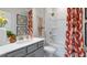 Fresh bathroom with a gray vanity, modern fixtures, and a shower-tub combination at 1346 Auburn Glen Rd, Dacula, GA 30019
