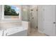 Bathroom features a soaking tub and glass enclosed shower, providing a spa-like feel at 1346 Auburn Glen Rd, Dacula, GA 30019