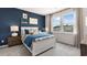Cozy bedroom with a blue accent wall and comfortable furnishings, offering a relaxing retreat at 1346 Auburn Glen Rd, Dacula, GA 30019