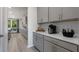 Butler's pantry featuring gray cabinetry, light countertops, and decorative elements at 1346 Auburn Glen Rd, Dacula, GA 30019