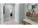 Inviting entryway with a bench, coat hooks, round mirror and access to other rooms at 1346 Auburn Glen Rd, Dacula, GA 30019