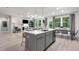 Open-concept kitchen flows into the living area, featuring an island with sink and modern finishes at 1346 Auburn Glen Rd, Dacula, GA 30019