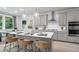 Modern kitchen with gray cabinets, an island, and stainless steel appliances at 1346 Auburn Glen Rd, Dacula, GA 30019