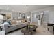 Spacious living area with a modern kitchen, comfortable seating, and an open staircase at 1346 Auburn Glen Rd, Dacula, GA 30019