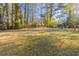 Large grassy backyard with mature trees, providing ample outdoor space at 2230 Star Mist Sw Dr, Atlanta, GA 30311