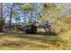 Side view of a ranch home nestled among mature trees at 2230 Star Mist Sw Dr, Atlanta, GA 30311