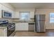 Eat-in kitchen with stainless steel appliances and granite countertops at 2230 Star Mist Sw Dr, Atlanta, GA 30311