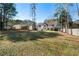 Large backyard with spacious grassy area and mature trees at 230 Bennett Farms Trl, Acworth, GA 30102