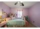Charming bedroom with light purple walls, a twin bed, and plenty of storage at 230 Bennett Farms Trl, Acworth, GA 30102