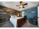 Bedroom with wood-look walls, ceiling fan, and comfortable seating at 230 Bennett Farms Trl, Acworth, GA 30102