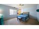 Spacious bedroom with light blue walls, carpeted floors, and a queen bed at 230 Bennett Farms Trl, Acworth, GA 30102