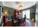 Bright dining room with dark wood table, red hutch, and hardwood floors at 230 Bennett Farms Trl, Acworth, GA 30102