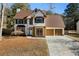 Two-story house with brown roof, white siding, and a two-car garage at 230 Bennett Farms Trl, Acworth, GA 30102