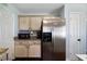 Kitchen boasts stainless steel refrigerator and microwave, granite countertops, and light-toned cabinets at 230 Bennett Farms Trl, Acworth, GA 30102