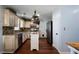 Kitchen with hardwood floors, white cabinets, granite counters, and island at 230 Bennett Farms Trl, Acworth, GA 30102