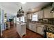 Open kitchen with island, pot rack, and granite countertops at 230 Bennett Farms Trl, Acworth, GA 30102