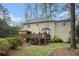 Large backyard with lush lawn, mature trees, wood deck, and patio area at 515 Lees Sw Trce, Marietta, GA 30064