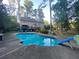 Inviting backyard pool with a built-in slide, deck, and plenty of space for Gathering fun and entertainment at 515 Lees Sw Trce, Marietta, GA 30064