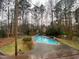 Backyard pool with patio and a view of the wooded property for summertime enjoyment at 515 Lees Sw Trce, Marietta, GA 30064