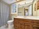 Neutral bathroom with a wood vanity, large mirror, and shower/tub combination at 515 Lees Sw Trce, Marietta, GA 30064
