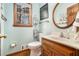 Charming half bathroom features a wood vanity, framed mirror, and modern fixtures at 515 Lees Sw Trce, Marietta, GA 30064