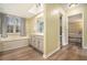 Bright bathroom with double vanity, soaking tub with tile surround and neutral paint at 515 Lees Sw Trce, Marietta, GA 30064