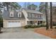 Charming two-story traditional home boasts a 2-car garage and inviting front porch with black shutters at 515 Lees Sw Trce, Marietta, GA 30064