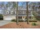 Charming two-story traditional home boasts a 2-car garage and inviting front porch with black shutters at 515 Lees Sw Trce, Marietta, GA 30064