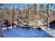 Wooded backyard with a stream, partially covered in snow at 4412 Brookview Se Dr, Atlanta, GA 30339