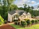 Craftsman style home with white brick exterior, landscaped yard, and a spacious driveway at 4412 Brookview Se Dr, Atlanta, GA 30339