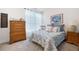 Cozy bedroom with floral bedding, a dresser, and plenty of natural light at 4980 Pleasantry Nw Way, Acworth, GA 30101