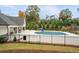 Community swimming pool with a safety fence and surrounding landscaping at 4980 Pleasantry Nw Way, Acworth, GA 30101