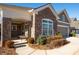 Inviting front porch with brick columns and comfortable seating area at 4980 Pleasantry Nw Way, Acworth, GA 30101