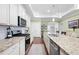 Well-equipped kitchen with granite counters, white cabinets, and gas range at 4980 Pleasantry Nw Way, Acworth, GA 30101