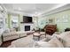 Spacious living room boasts a fireplace, comfortable seating, and large windows at 4980 Pleasantry Nw Way, Acworth, GA 30101