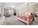 Spacious main bedroom with a post bed, sitting area, and backyard access at 4980 Pleasantry Nw Way, Acworth, GA 30101